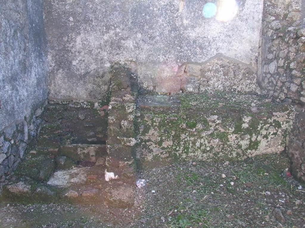 I.9.10 Pompeii. December 2006. Kitchen, with latrine and bench.
