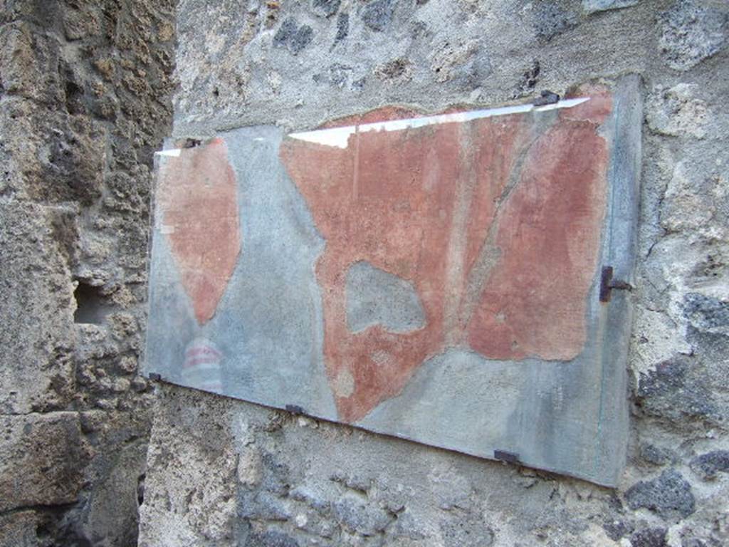 I.10.3 Pompeii. December 2006. Painted plaster on west side of entrance.