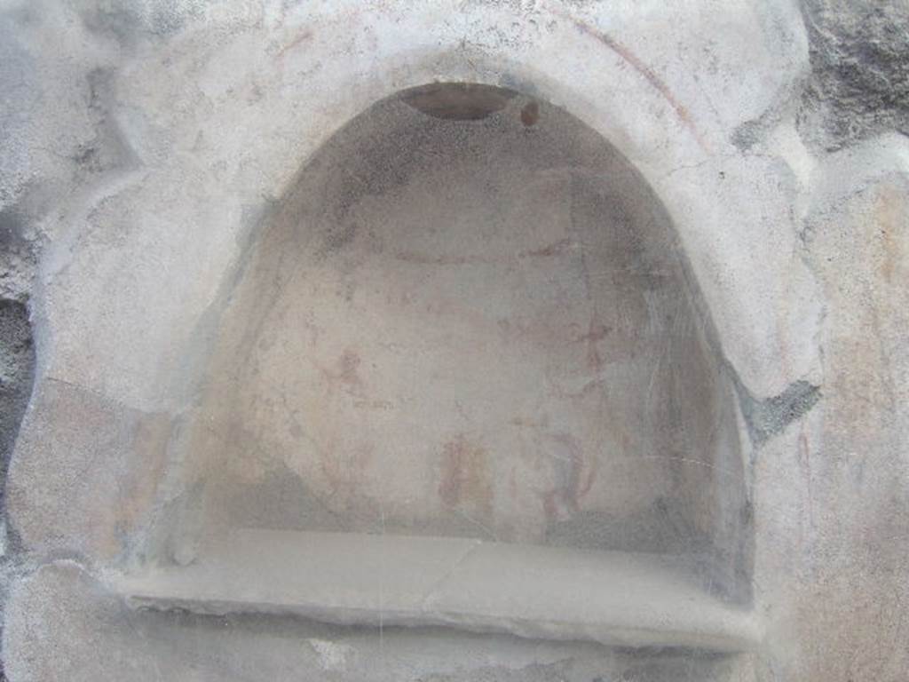 I.10.3 Pompeii. December 2006. Niche on east wall of fauces.
Fröhlich described a painted round altar, small snake, two Lares and an inscription “Felix aeris IV as, Florus X”. See Fröhlich, T., 1991, Lararien und Fassadenbilder in den Vesuvstädten. Mainz: von Zabern. (L13 p.255). Varone refers to the inscription as painted in red on a small aedicule located in the vestibulum. “Felix aeris as(sibus) IV, Florus X”.
According to Varone, CIL IV 7339 is translated as “Felix for four asses, Florus for ten”. See Varone, A., 2001, Erotica Pompeiana: Love Inscriptions on the Walls of Pompeii. Rome: L’ Erma di Bretschneider. (p.154). See Varone, A. and Stefani, G., 2009. Titulorum Pictorum Pompeianorum, Rome: L’erma di Bretschneider (p.120 for a drawing of the graffito, which Varone and Stefani say is no longer conserved).