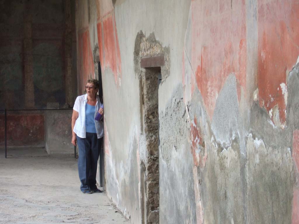 I.10.4 Pompeii. May 2006.
West portico, with doorway to room 46 the baths entrance, and doorway to corridor M, leading to the kitchen and services area.