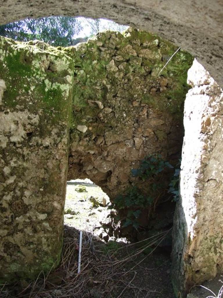 I.10.4 Pompeii. March 2009. Looking out from third lower floor storeroom C. Latrine? Wall dividing lower floor rooms and outside area. According to Allison, �The fixtures in this room [C] included a latrine in the northwest corner, ostensibly outside this room�. See Allison, P.M., Pompeian Households: An online companion. http://www.stoa.org/projects/ph/rooms?houseid=9#212 (Room C).