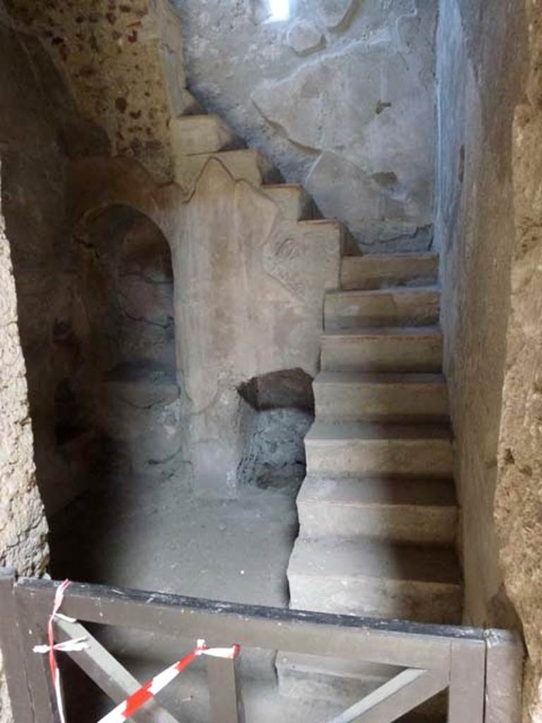 I.10.4 Pompeii. June 2012. Room 2, niche and recess below stairs to upper floor. According to Boyce, in a small room with an arched recess beneath the stairs, there was a small masonry altar with two cavities in the top, and a niche in the wall above. See Boyce G. K., 1937. Corpus of the Lararia of Pompeii. Rome: MAAR 14. (50C on p.28). He quoted his reference as MAIURI, Casa del Menandro, 37. Photo courtesy of Michael Binns.