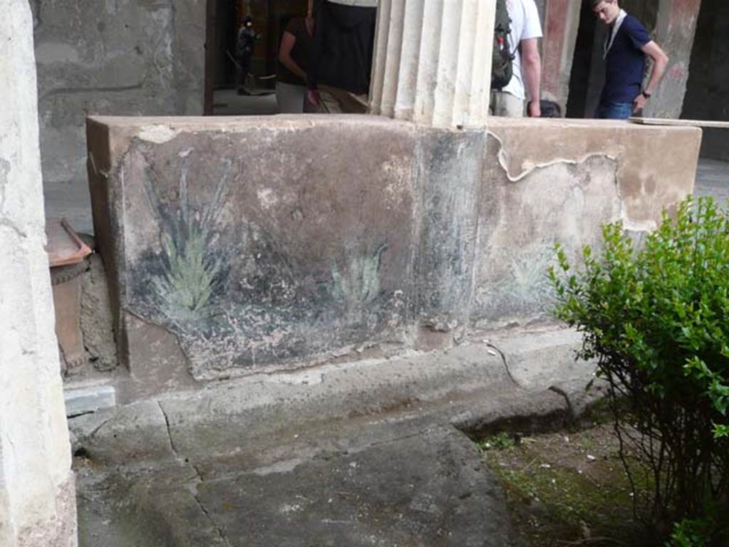 I.10.4 Pompeii. May 2012. Looking towards north portico and painted pluteus, with terracotta puteal, on left. Photo courtesy of Buzz Ferebee.