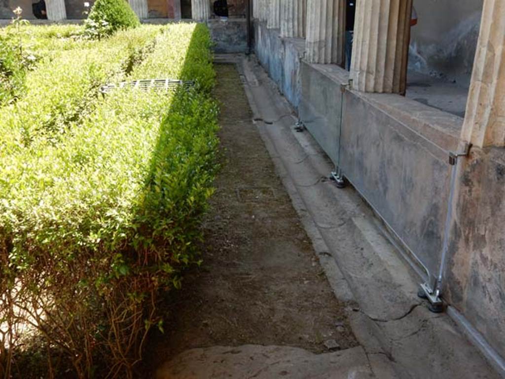 I.10.4 Pompeii. May 2017. Looking south along gutter in garden near west portico with remains of painted pluteus. Photo courtesy of Buzz Ferebee.
