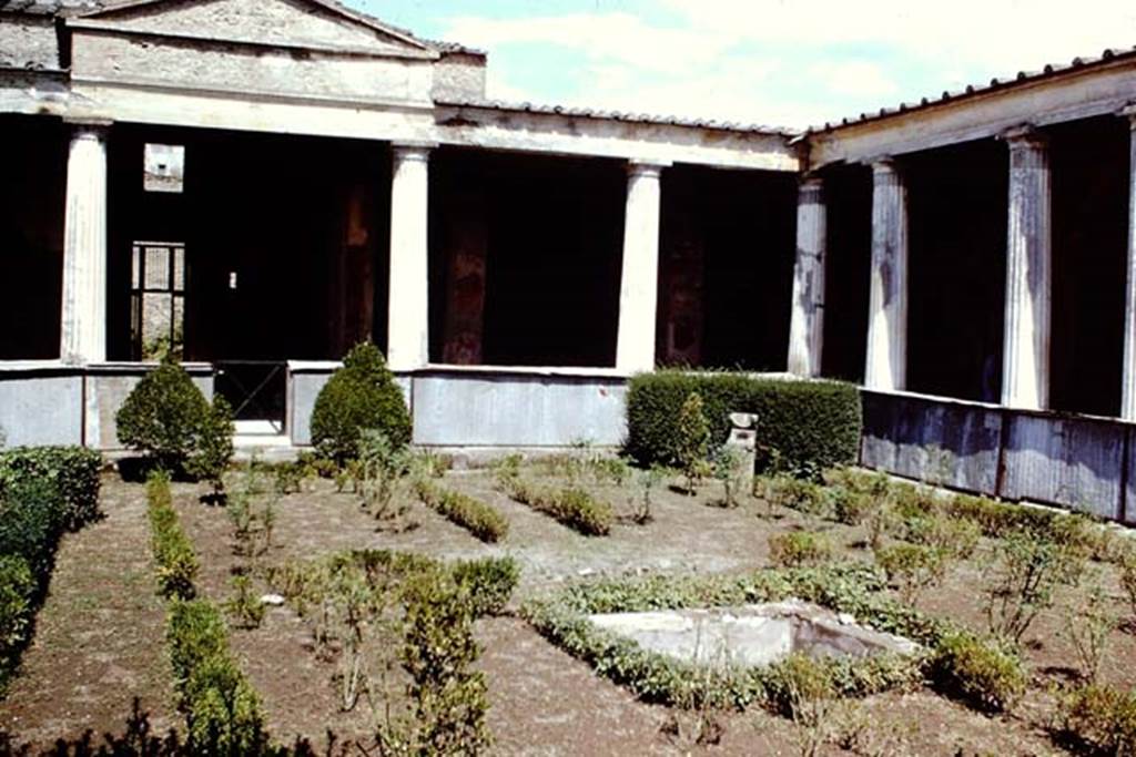 I.10.4 Pompeii, 1968. Looking towards north and north-east corner of peristyle. Photo by Stanley A. Jashemski.
Source: The Wilhelmina and Stanley A. Jashemski archive in the University of Maryland Library, Special Collections (See collection page) and made available under the Creative Commons Attribution-Non-Commercial License v.4. See Licence and use details.
J68f1001
According to Jashemski –
“The imprint of a wooden triclinium, which occupied a rectangular area 1.74 x 2.69m, was found in the garden, and on the south side of the triclinium was a square pool with a fountain. There was a spherical sundial in the north-east of the garden”.
See Jashemski, W. F., 1993. The Gardens of Pompeii, Volume II: Appendices. New York: Caratzas. (p.47).
According to Soprano –
Ubiczione: peristilio.
Bibliog. Maiuri, La Casa del Menandro e il suo tesore di argenteria. (Roma, 1939), p.84 and fig.a on p.75.
Nel peristilio furono rinvenute le impronte di un triclinio ligneo.
Occupava un’area rettangolare di m.1.74 per 2.69; ad ovest del triclinio c’era una piscina quadrata.
See Soprano, P. (1950). I triclini all’aperto di Pompei. (In Pompeiana, raccolta di studi per il secondo centenario degli scavi di Pompei. Napoli, Gaetano Macchiaroli, Editore, P. 307, no.31).
