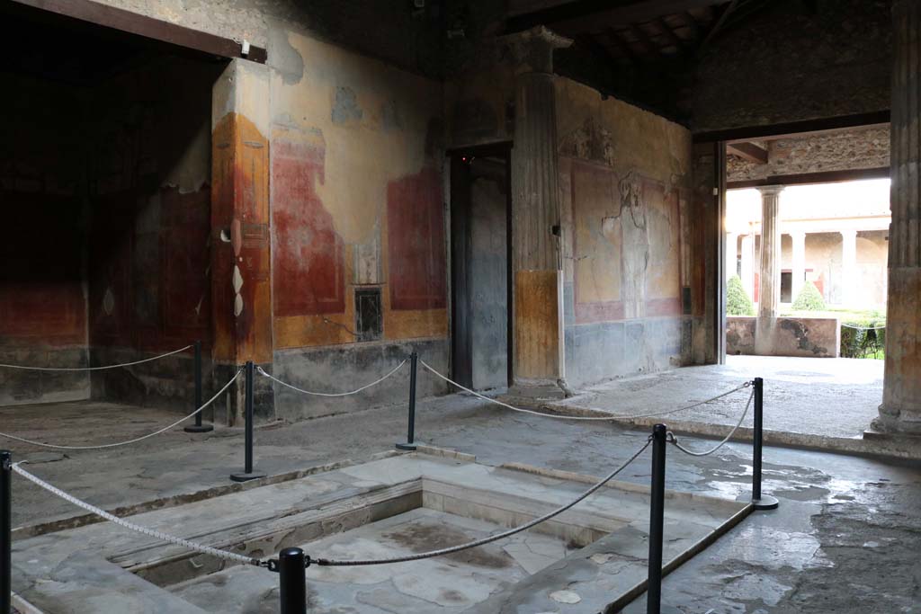I.10.4 Pompeii. December 2018.
Atrium, looking towards east wall in south-east corner, near corridor 9 and tablinum 8. Photo courtesy of Aude Durand.
In the atrium are paintings of architectural scenes, theatrical masks, portrait medallions and birds, including ducks and a parrot.