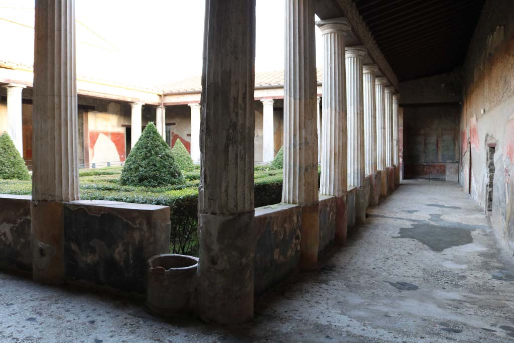 I.10.4 Pompeii. December 2018.
Looking south-east across peristyle, and south along west portico towards south-west corner. Photo courtesy of Aude Durand.
On both the garden and portico sides of each wall between every two columns are scenes of hunts, and paintings of birds and plants.
On the left is an embedded puteal above a cistern mouth.
On both the garden and portico sides of each wall between every two columns are scenes of hunts and paintings of birds and plants.