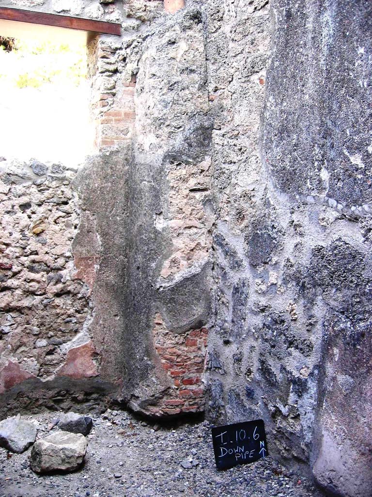 I.10.6 Pompeii. July 2008.
Looking towards north-east corner, with downpipe from upper room. Photo courtesy of Barry Hobson.
