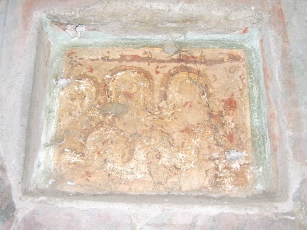 I.10.7 Pompeii. March 2009. Room 12, east wall of triclinium.  
Lararium niche set in third style decoration. Two crested and bearded brown serpents with yellow underbellies are creeping to the left between red flowers and green plants. On the right is an altar.
See Fr�hlich, T., 1991. Lararien und Fassadenbilder in den Vesuvst�dten. Mainz: von Zabern. (L15: p.256)
According to Boyce, this shallow rectangular niche was set into (but not in the centre of) a fine panel of wall decoration, which it disfigured.
(According to the note by Boyce, Elia had said in Not.Scavi, that these panels were painted shortly after the earthquake of 63 AD).
Both serpents coil from the left towards an altar, as in the other lararium described in the kitchen. In the background were green plants with red flowers. Not. Scavi, 1934, 287.
See Boyce G. K., 1937. Corpus of the Lararia of Pompeii. Rome: MAAR 14. (p.29, no.57)

