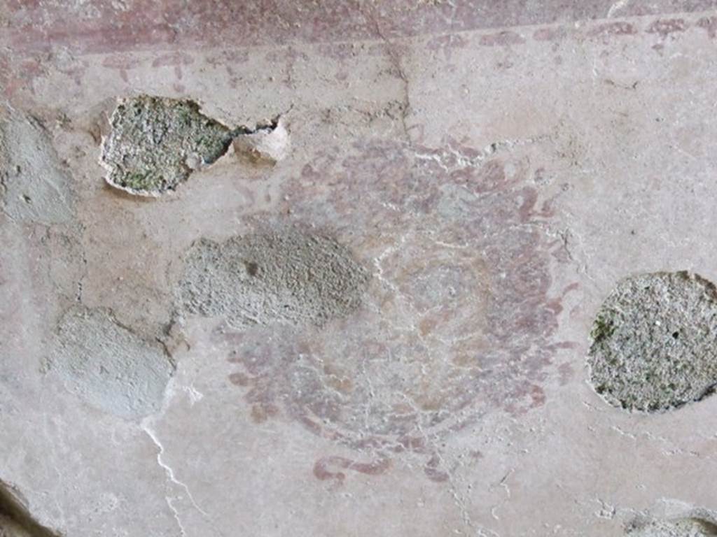 I.10.8 Pompeii. March 2009. Room 8, west wall of tablinum. Remains of a painting of a Gorgon from the centre of the lower section.