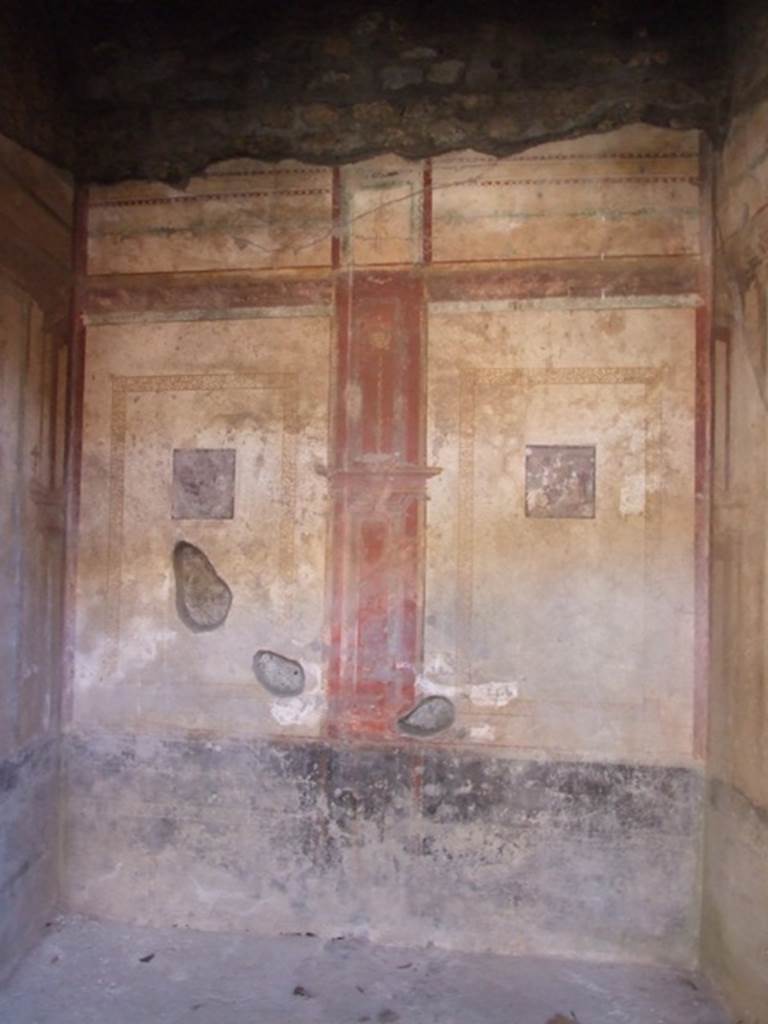 I.10.11 Pompeii. March 2009. Room 6, south wall of ala or exedra.
According to Peters, two small landscapes were to be seen on the southern wall of the exedra, south of the atrium.
These were in the centres of the side panels. The wall was divided into two parts by a central red compartment.
See Peters, W.J.T. (1963): Landscape in Romano-Campanian Mural Paintings. The Netherlands, Van Gorcum & Comp. (p.151)
