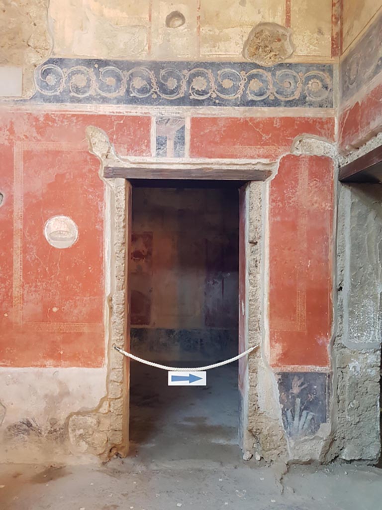 I.10.11 Pompeii. October 2022.
Room 2, north-west corner of atrium, with doorway to room 9 in west wall. Photo courtesy of Klaus Heese.