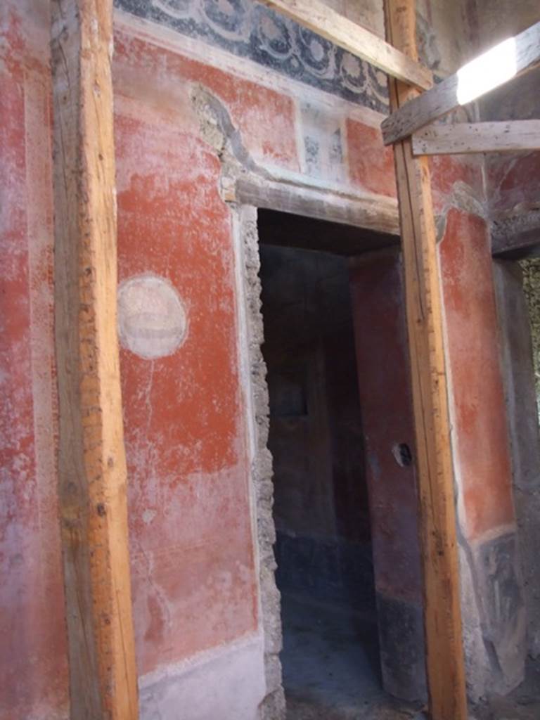 I.10.11 Pompeii. March 2009. Room 2, north-west corner of atrium.
Doorway to room 9 in west wall, with painted medallion on wall to south.