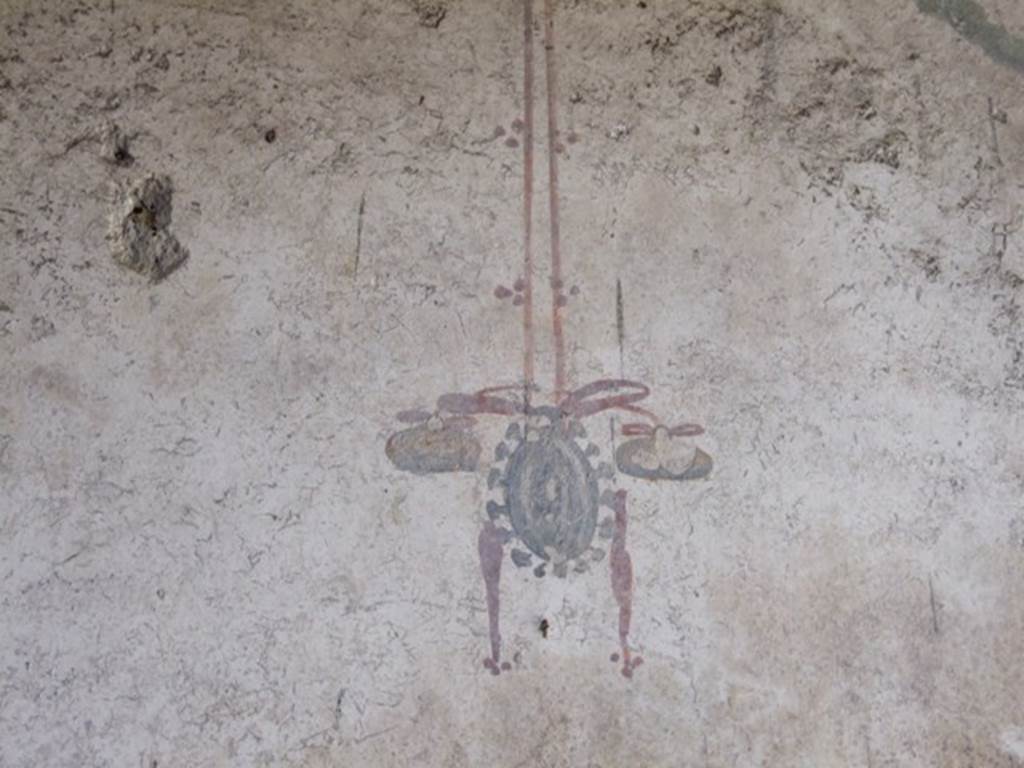 I.10.11 Pompeii. March 2009. Room 10, painting of hanging tambourine from east end of north wall of peristyle. See Bragantini, de Vos, Badoni, 1981. Pitture e Pavimenti di Pompei, Parte 1. Rome: ICCD. (p.145).
