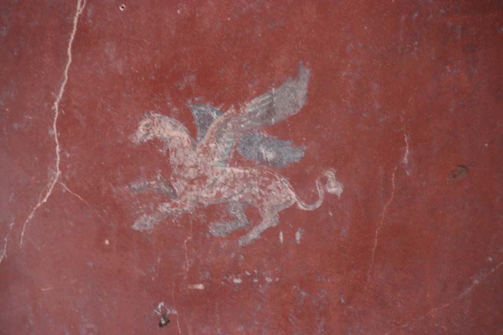 I.10.11 Pompeii. September 2021.
Room 12, painting of Pegasus from centre of panel at south end of east wall of cubiculum. Photo courtesy of Klaus Heese.