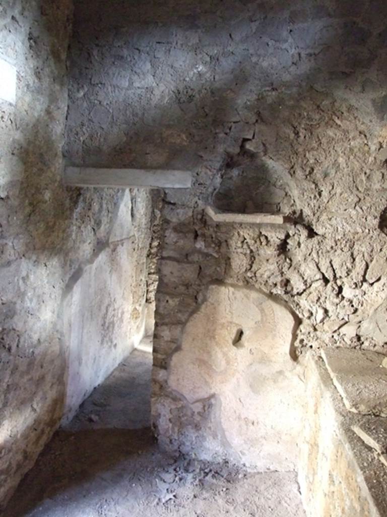 I.10.11 Pompeii. March 2009.
Room 15, east wall of kitchen with niche and remains of painted serpent from lararium painting.
On the left is the doorway to room 16.