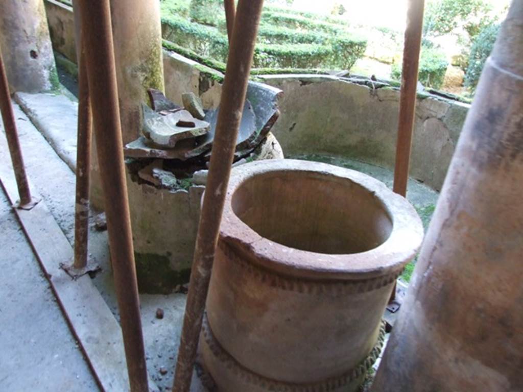 I.10.11 Pompeii. March 2009. Room 10. Peristyle. Puteal and remains of large basin in south east corner.