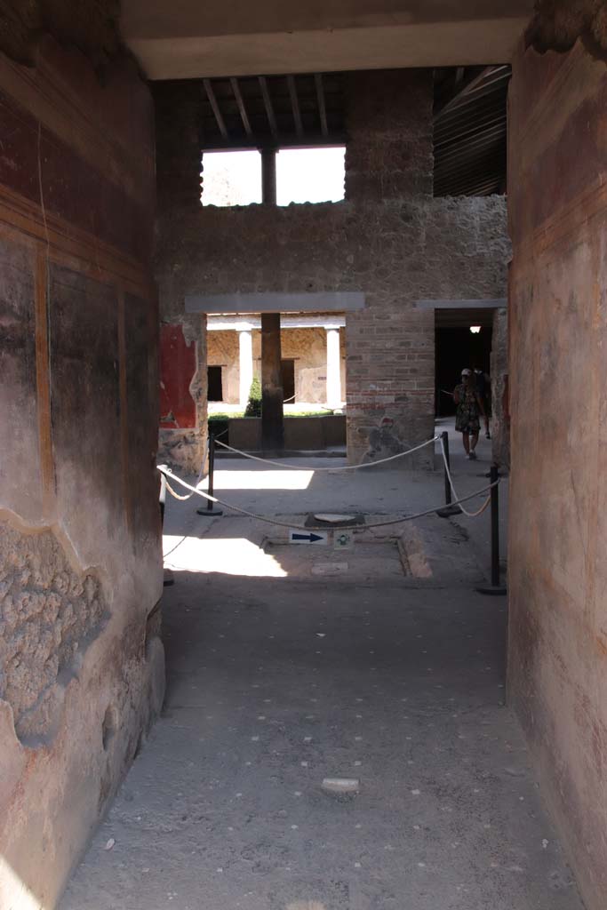 I.10.11 Pompeii. September 2021.
Room 1, looking east across entrance corridor towards room 2, atrium. Photo courtesy of Klaus Heese.
