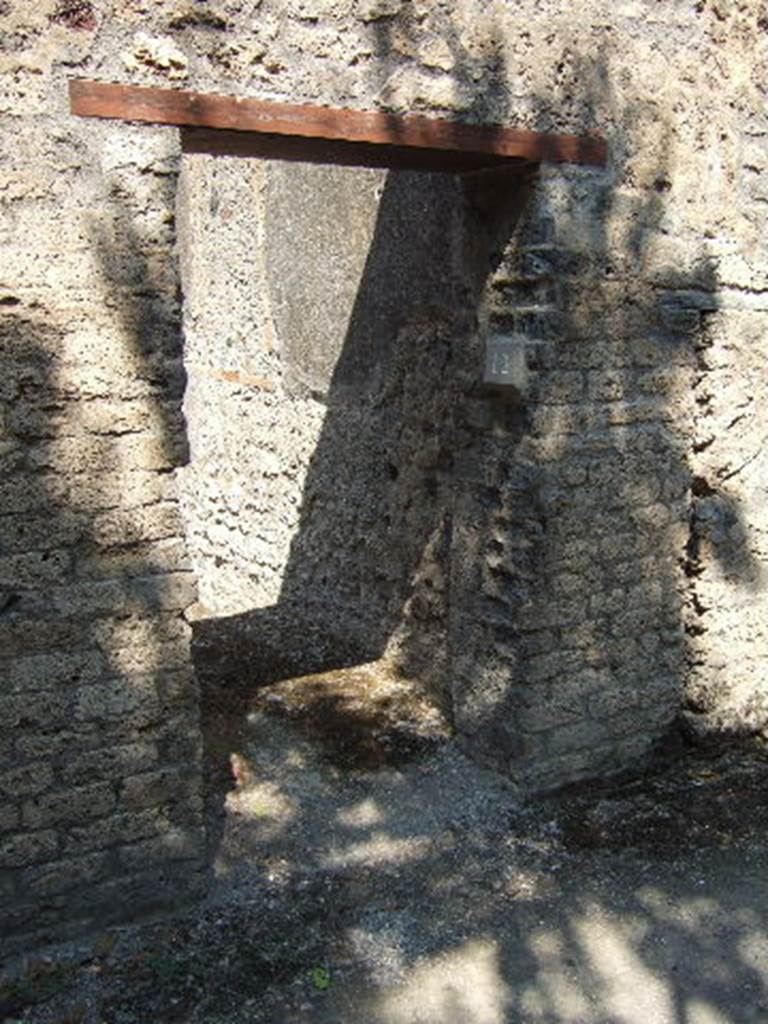 I.10.12 Pompeii. September 2005. Narrow entrance doorway.
According to NdS –
With jambs and sockets of tuff, and with a wooden threshold, access was gained to a spacious room.
This had a cocciopesto floor, walls covered with rough plaster, and a flat ceiling; the door opened to the left of the wall, to increase the lighting of the room, and a rather wide rectangular window was carved into the same south wall.
In the centre of the east wall, was a large breach from the corresponding rustic room of the Casa del Menandro and on the same wall a small doorway of communication, now closed, with the latrine of the same room.
In the west wall, the block of limestone that marked the beginning of the staircase to the upper floor was resting on the ground.
See Notizie degli Scavi, 1934, (p.340)