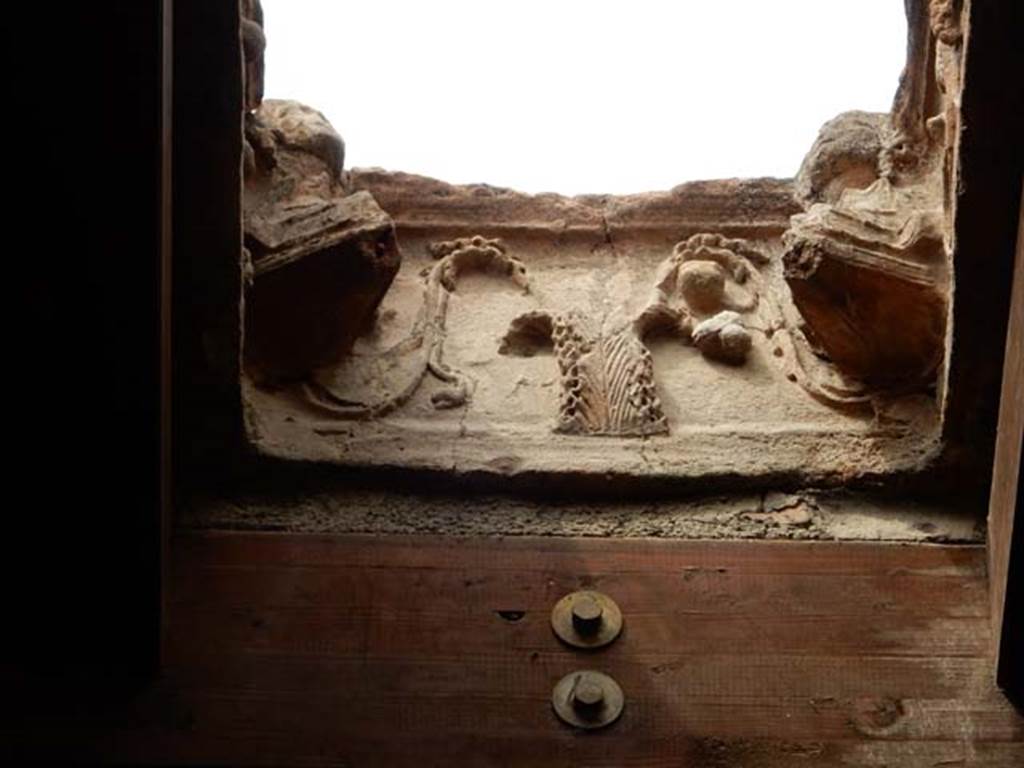 I.10.16 Pompeii. May 2017. Terracotta compluvium above atrium. Decorated relief on side which has satyr’s head missing. Photo courtesy of Buzz Ferebee.