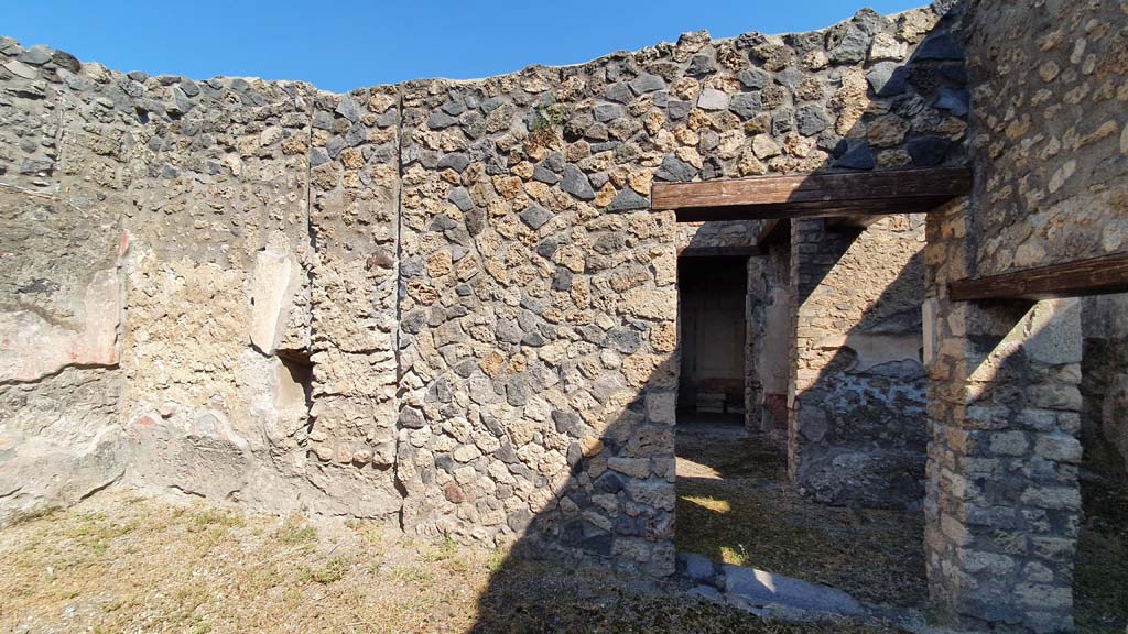 I.11.1 Pompeii. July 2021.
Looking north from room on south side of bar-room, looking towards doorway to cubiculum and ala, centre right.
The doorway on the right led into the room with the benches and lararium.
Foto Annette Haug, ERC Grant 681269 DÉCOR.