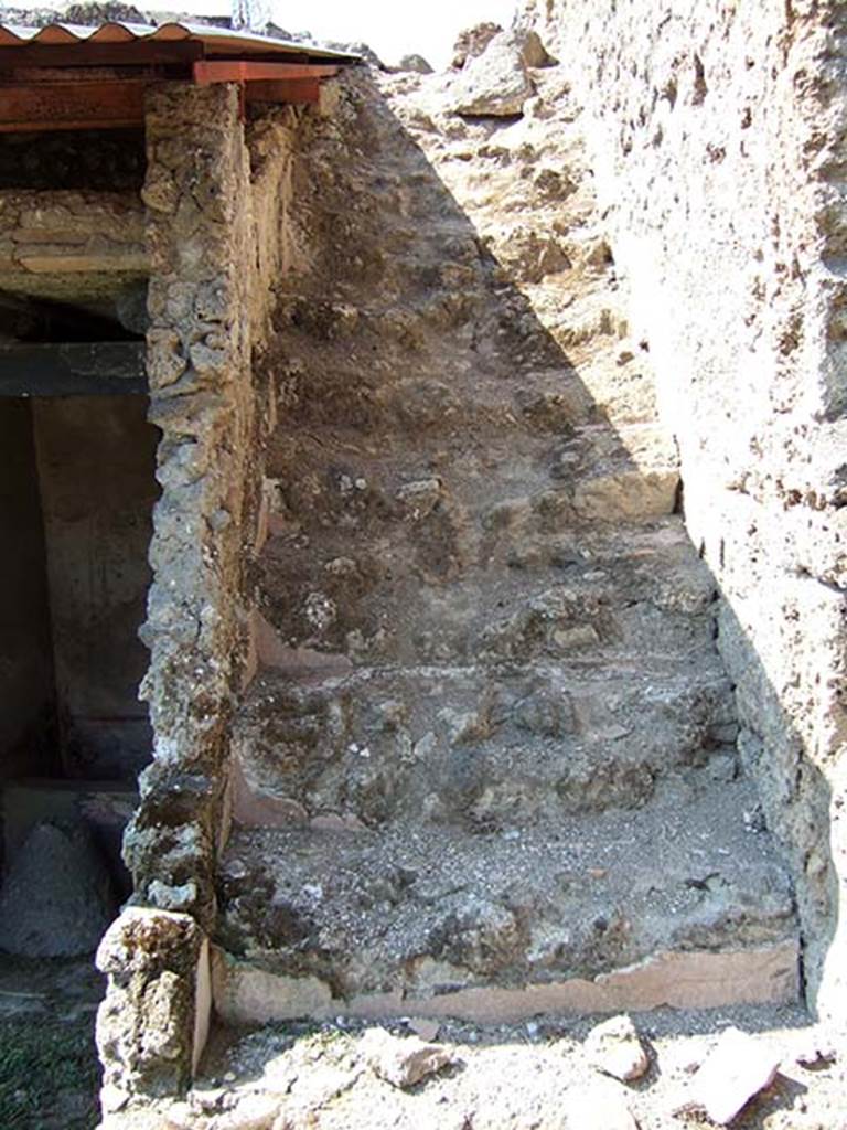 I.11.10 Pompeii. September 2005.
Stairs to upper floor, with latrine at the rear on the left.