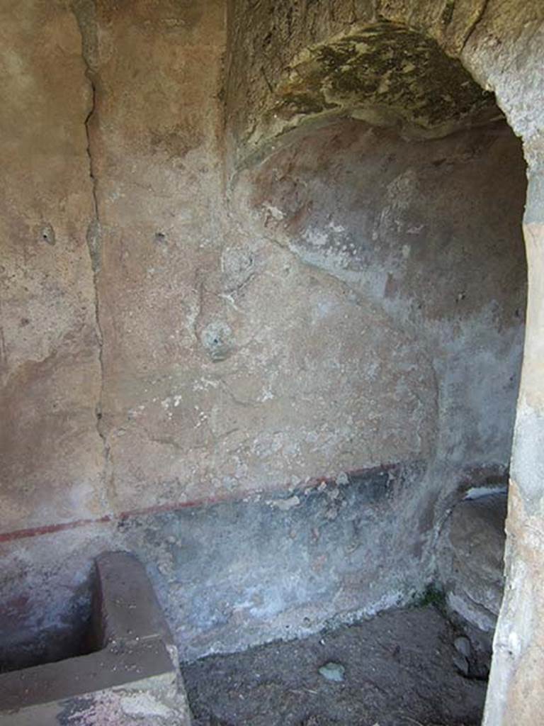 I.11.10 Pompeii. September 2005. Latrine with small water basin.
According to Hobson, this latrine which had its entry from the garden, was a rarity in Pompeii as it had its own water tank.
The room was decorated with a black dado topped by a red-line, making it one of the few well decorated latrines. (Jansen 1993).
See Hobson, B., 2009. Latrinae et foricae: Toilets in the Roman World. London; Duckworth. (p. 122).