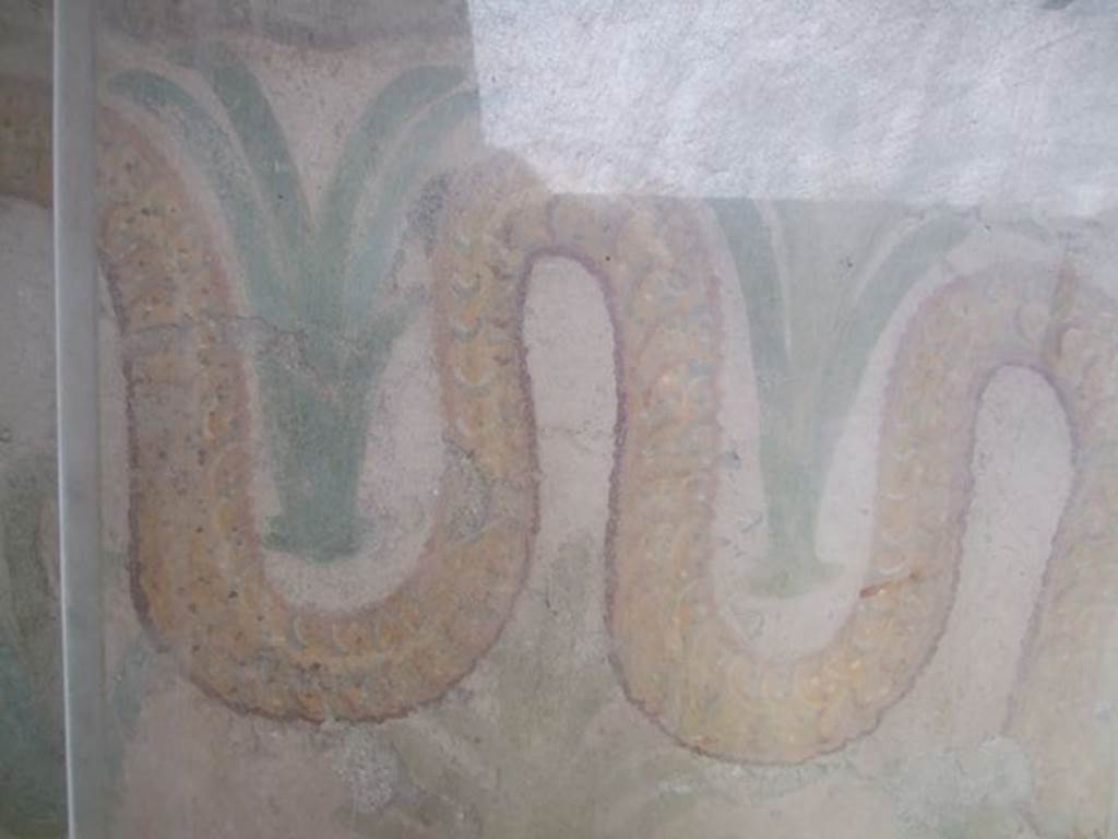 I.11.11 Pompeii. May 2006. Lararium. Detail of snake and perennial plants.