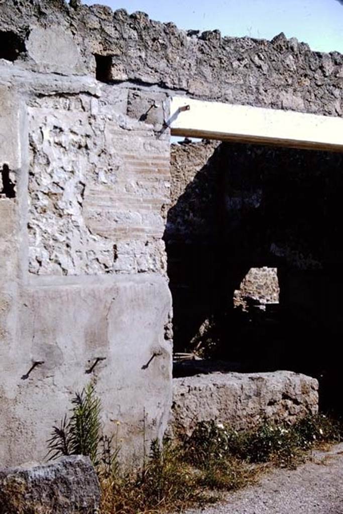 I.11.11 Pompeii. 1964. Looking north to entrance doorway, with remains of inscription on its western side. In this photo, the sign of the phoenix has been removed, but below its site CIL IV 9851 can still be read. Photo by Stanley A. Jashemski.
Source: The Wilhelmina and Stanley A. Jashemski archive in the University of Maryland Library, Special Collections (See collection page) and made available under the Creative Commons Attribution-Non Commercial License v.4. See Licence and use details.
J64f1470