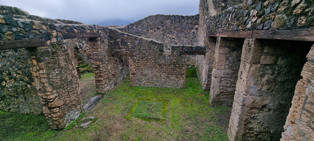 I.11.14 Pompeii. January 2023.
Looking south across impluvium in atrium, with doorway to small peristyle garden, centre left. Photo courtesy of Miriam Colomer.