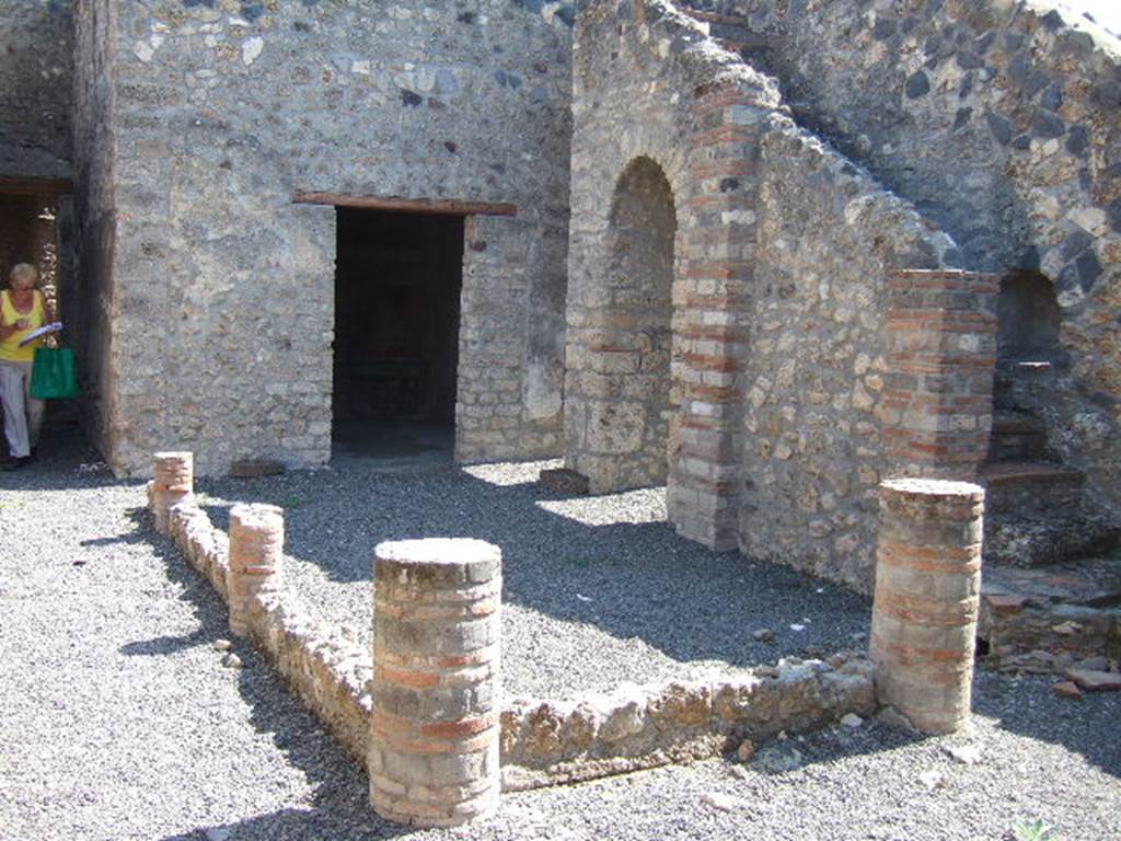 I.11.14 Pompeii. September 2005. Looking east across the peristyle garden.
According to Jashemski, this was enclosed by a portico on the west, north and east supported by four columns. These columns were joined on the west and north by a low wall. At the time of excavation, there was a gutter and in the west portico, a terracotta cistern puteal, neither are now visible.
See Jashemski, W. F., 1993. The Gardens of Pompeii, Volume II: Appendices. New York: Caratzas. (p.52)
On the left can be seen the corridor to the rear of the house, and doorway to Oecus, in the centre.