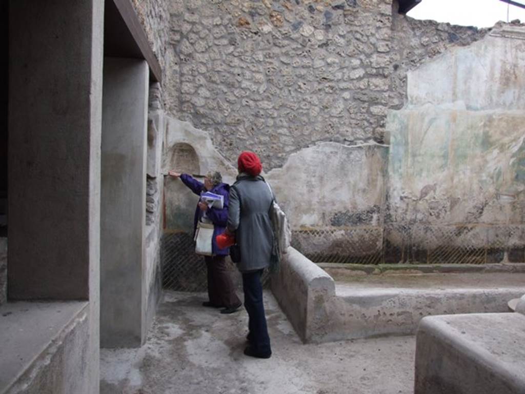 I.11.16 Pompeii. December 2007. Room 6, looking north towards triclinium and two niches.
The walls are painted with style IV garden scenes, with a black dado divided by yellow lines into a trellis pattern, and set off by a yellow border.