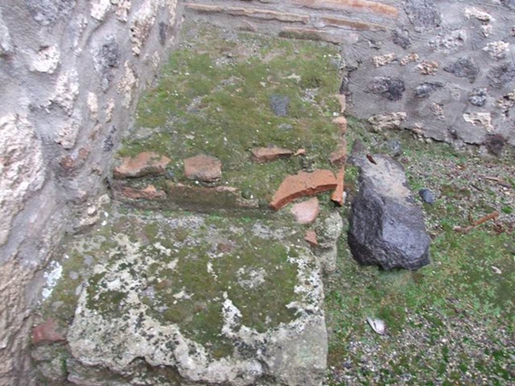 I.11.16 Pompeii. December 2007. Room 10, north-east corner with masonry base for wooden steps to upper floor. According to Packer, the area reached by the wooden steps would have been above rooms 10-12 and would probably have been a single large chamber, perhaps a dormitory.