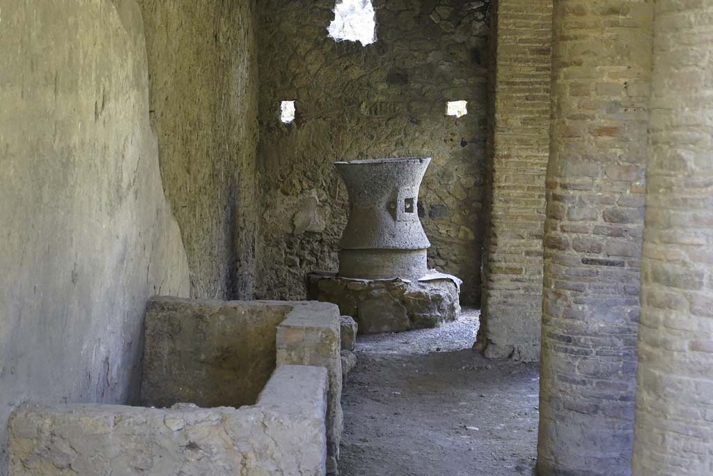 I.12.1 and I.12.2 Pompeii. August 2021. Room 3, detail of room with mills, looking south through window. Photo courtesy of Robert Hanson.
