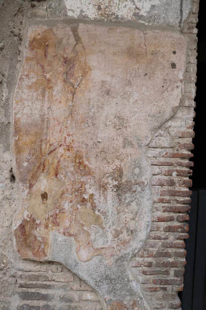 I.12.3 Pompeii. December 2018.
Detail of remaining plaster on pilaster between doorways I.12.4 and I.12.3. Photo courtesy of Aude Durand.