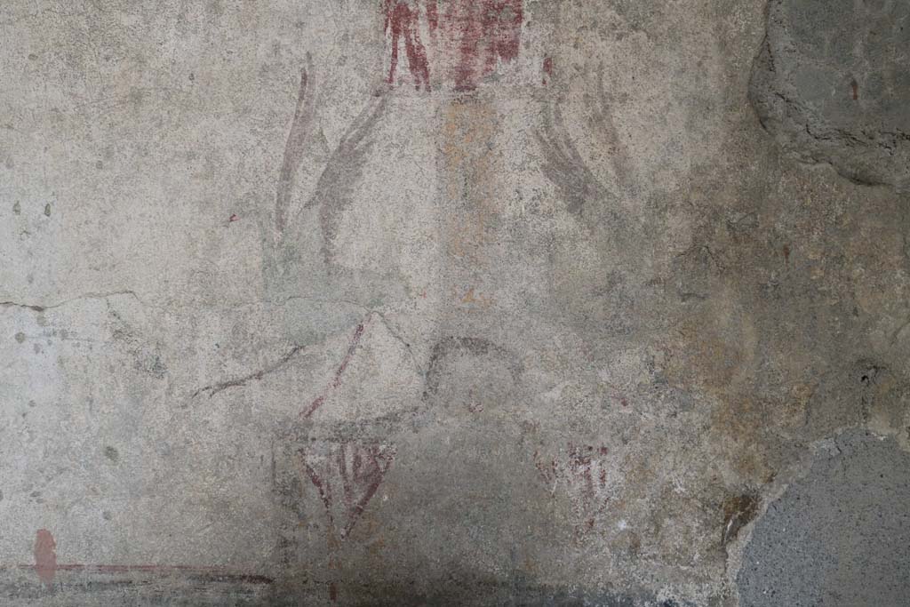 I.12.5 Pompeii. December 2018. Detail of painted decoration on east side of middle zone of north wall.
At the base of the painted candelabra are two painted herons. Photo courtesy of Aude Durand.