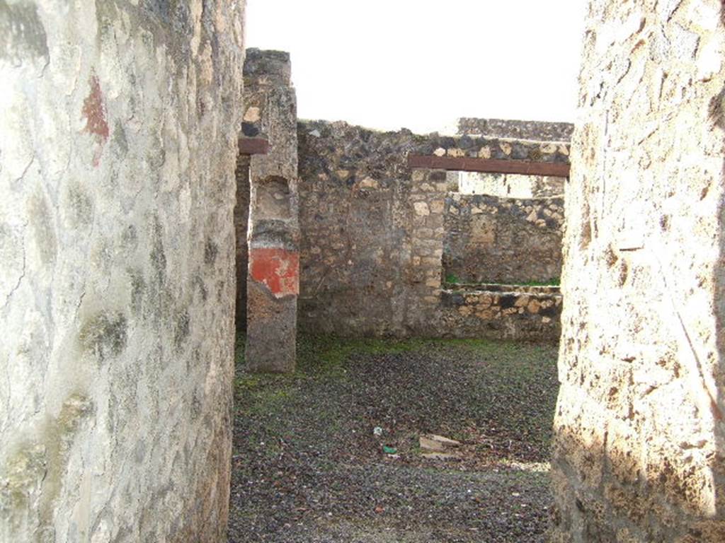 I.12.7 Pompeii. December 2005. Looking west from entrance, through window to garden area.