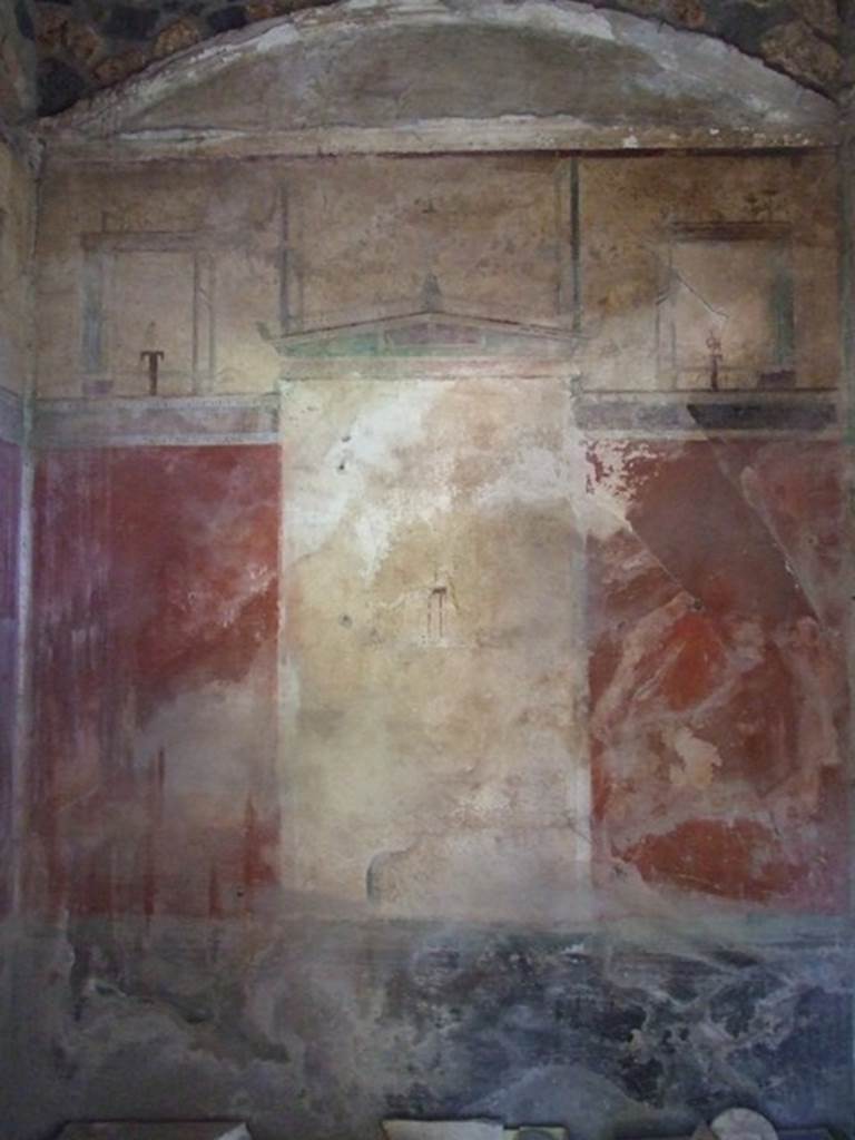 I.12.8 Pompeii. March 2009. Room 11, north wall of cubiculum. According to Curtis, on Eschebach’s 1969 plan of the house a doorway is shown from this cubiculum into the house at I.12.14. This is an error. See Curtis R.L: The Garum shop of Pompeii, In Cronache Pompeiane, V.1979, p.8, note 5. He also described this room as having a beautiful third style wall painting on three of its walls. The bordering appeared in deep green and the architectural structure above the panels contained differently shaped amphorae.
A large panel on each of the three walls contained a simple idyllic scene on a white background. See Curtis R.L: The Garum shop of Pompeii, In Cronache Pompeiane, V.1979, (p.20).