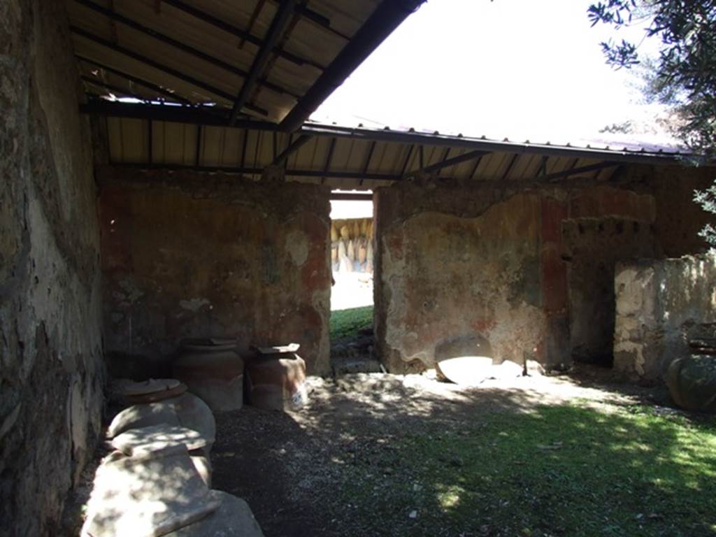 I.12.8 Pompeii. March 2009. Room 9, north wall of peristyle garden. On both sides of the doorway to the rear garden was a garden painting. Curtis described it as a large, brightly coloured painting, divided in the centre by the doorway leading into the rear courtyard.
Each half of the painting was bordered by a wide, red band. At each corner the artist painted an amphora in gold inside of a square with painted black background. See Curtis R.L: The Garum shop of Pompeii, In Cronache Pompeiane, V.1979, (p.19). See Jashemski, W. F., 1993. The Gardens of Pompeii, Volume II: Appendices. New York: Caratzas, (p.54-55 and p.326 & fig.378)