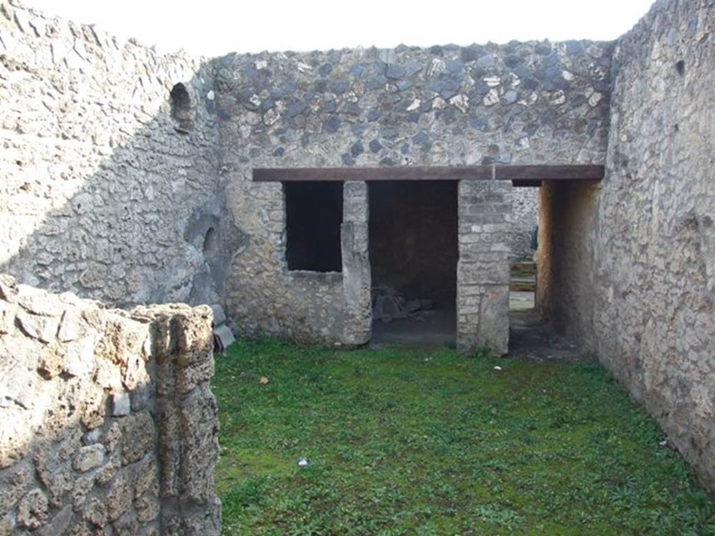 I.12.9 Pompeii. December 2007. Looking south across atrium from tablinum area, towards entrance, on right. On the left can be seen the niches in south-east corner of atrium, as well as a doorway and window to the triclinium. According to Wallace-Hadrill, this room had faded but elegant white-ground style-III decorations. See Wallace-Hadrill, A. (1994). Houses and Society in Pompeii and Herculaneum. Princeton Univ.Press, (p.196/7)