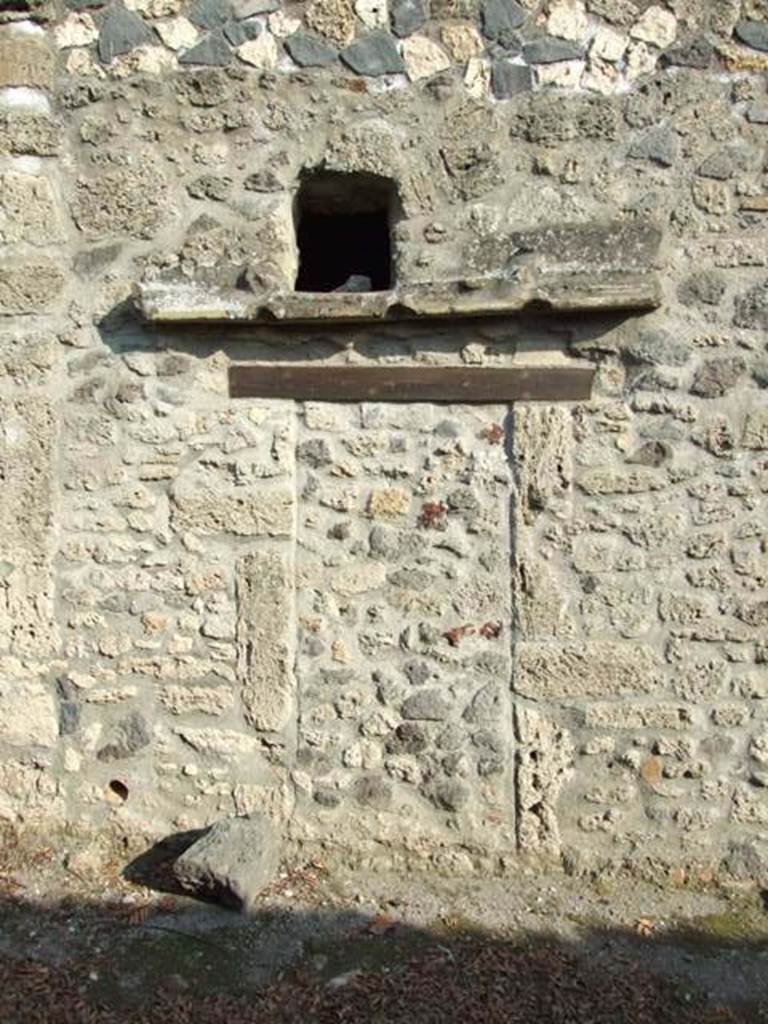 I.12.11 Pompeii. December 2007.
Blocked doorway, sill and window into small room next to kitchen.
Looking east from Vicolo della Nave Europa.