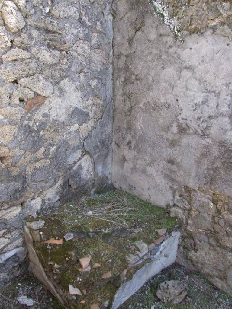 I.12.15 Pompeii. March 2009. Square masonry base in south east corner outside room 6.