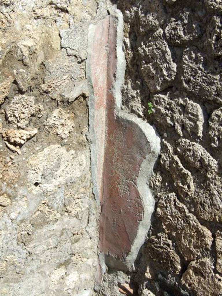 I.12.15 Pompeii. March 2009. Room 7. Remains of painted plaster in north east corner