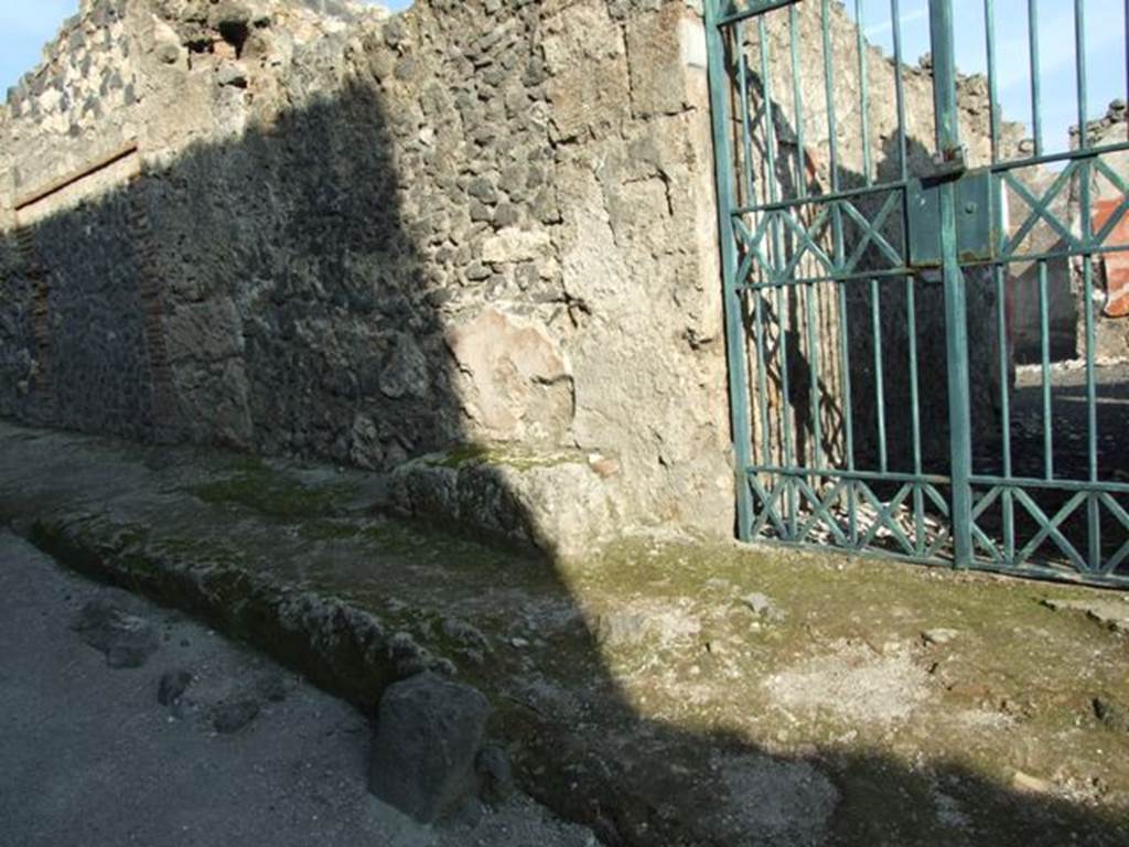 I.12.16 Pompeii. December 2007. Wall and bench to north of entrance.