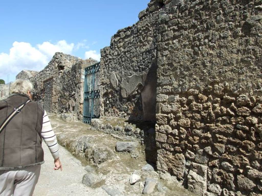 I.12.16 Pompeii. March 2009. Vicolo delle Nave Europa, looking north, outside south side of entrance.