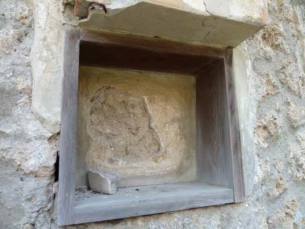 I.13.2 Pompeii. May 2010. Niche of Lararium.
According to Jashemski, a bronze statuette of Athena, SAP inventory number 10560, was found here.
It was on a base with the inscription THEODOR MAS.
See Jashemski, W. F., 1993. The Gardens of Pompeii, Volume II: Appendices. New York: Caratzas. (p.56).