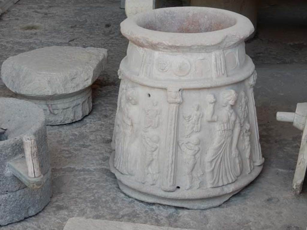I.13.8 Pompeii? May 2018. Terracotta puteal with moulded decoration of columns and Bacchic figures in storage in VII.7.29.
According to Roberts,
there are three scenes divided by columns each showing a Maenad with tambourine and castanets with seated figures, perhaps Bacchus, and satyrs playing the twin pipes (auloi).
See Roberts, P., 2013. Life and Death in Pompeii and Herculaneum. London: British Museum Press, p. 153, fig. 167.
PAP inventory number 44908.
Photo courtesy of Buzz Ferebee.