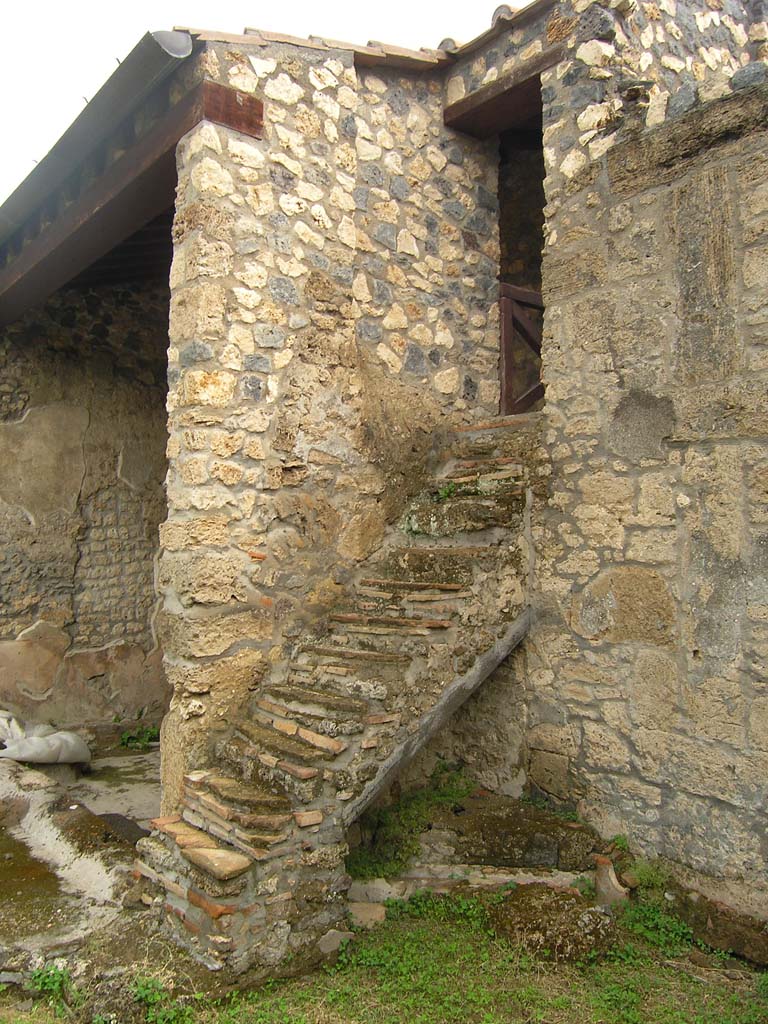 I.14.2 Pompeii. July 2008. Stairs to upper floor, on east side of garden area M.
Photo courtesy of Guilhem Chapelin.