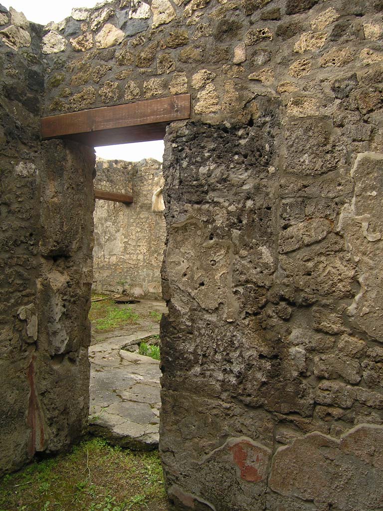 I.14.2 Pompeii. July 2008. Room C, south west corner, west wall and doorway to atrium.
Photo courtesy of Guilhem Chapelin.