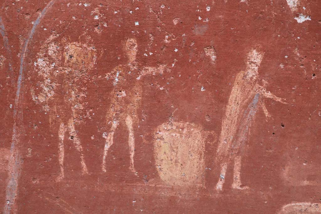 I.14.7 Pompeii. December 2018. Detail from lararium, right to left.
A man in a long garment, making a gesture in direction of the weighing machine/scales.
A second man in a short robe with outspread arms making a gesture over a basket and another man carrying a basket on his left shoulder.
Photo courtesy of Aude Durand.